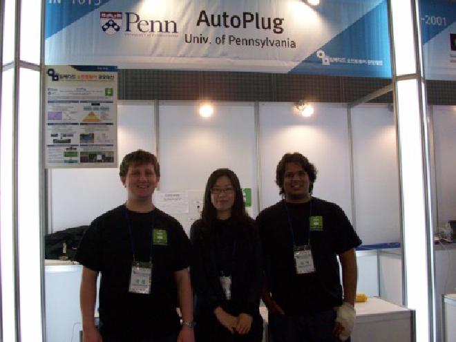 Picture of AutoPlug team in front of booth