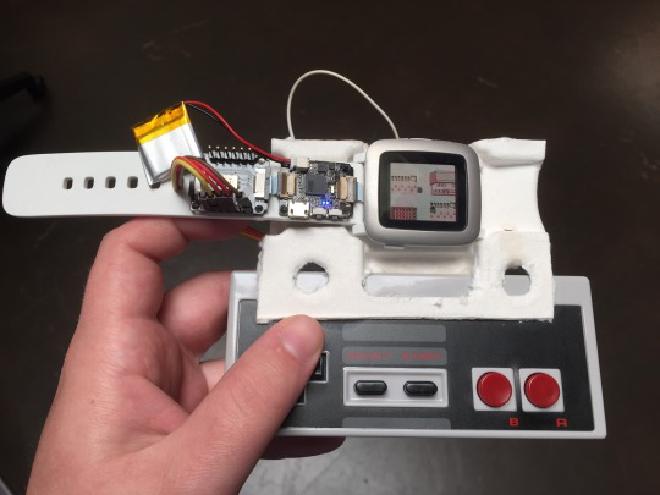 Picture of NES controller connected to Pebble Time via smart strap to control the Game Boy emulator