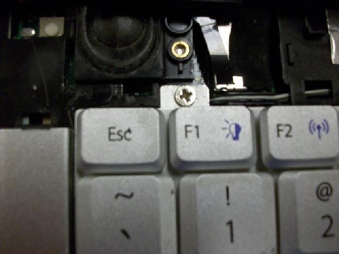 Picture of screw above F1 key