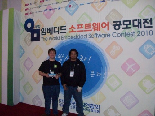 Madhur and I in front of a WESC wall holding the AutoPlug gateway